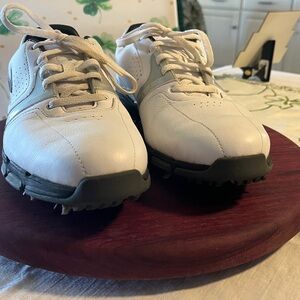 Nike White and Black Women’s Golf Shoes with cleats.  Red Swoosh